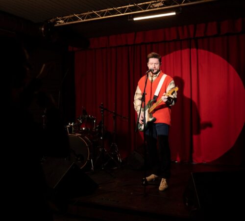 full-shot-man-performing-stage_23-2149247138